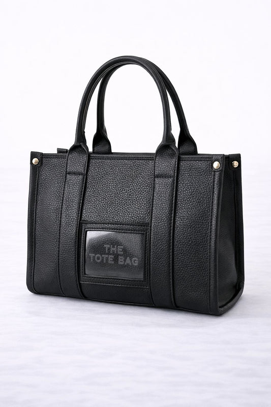 Zwarte The Tote Bag met een verfijnde en luxe uitstraling.